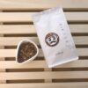 Showcase of the cascara product alongside a sealed bag of cascara