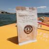 Bag of Nicaragua Finca Santa Maria de Lourdes coffee next to the sea